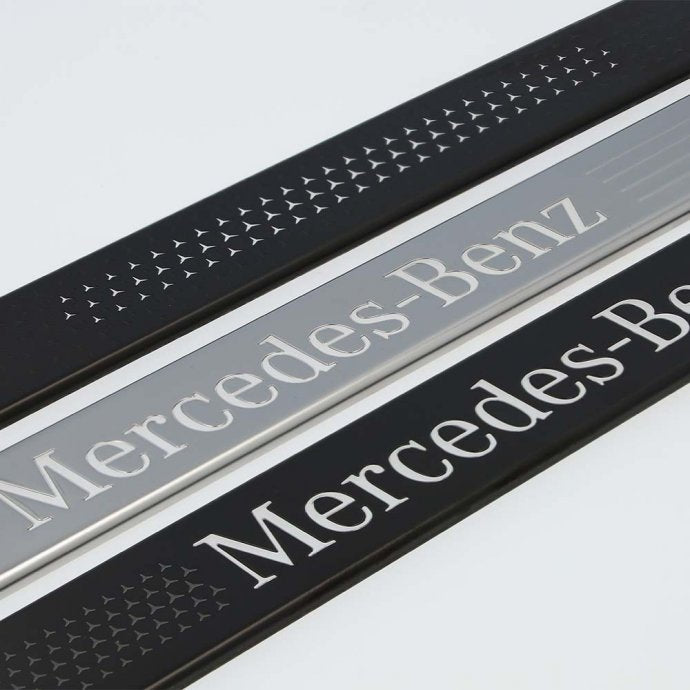 Interchangeable cover for illuminated door sill panel, Mercedes-Benz, front, 2-fold, with Mercedes-Benz pattern (black)